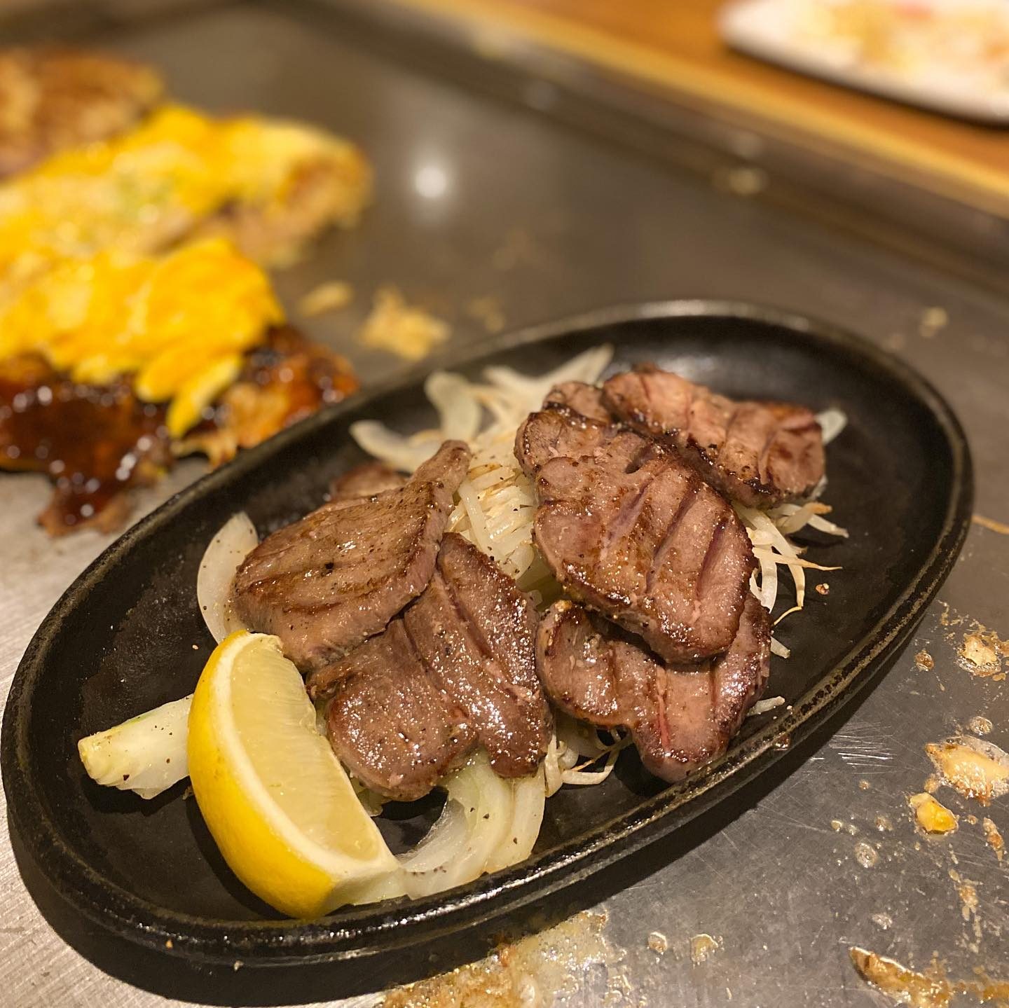 玉ねぎとレモンを添えた鉄板焼きのお肉