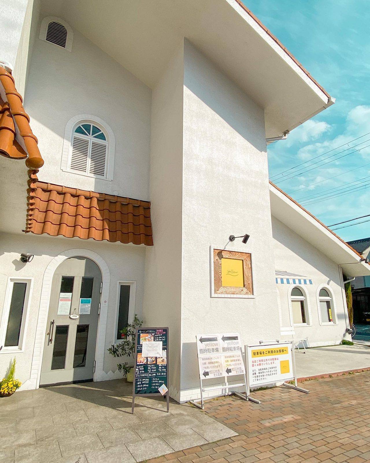 オレンジ色の屋根と白い壁がかわいいお店の外観